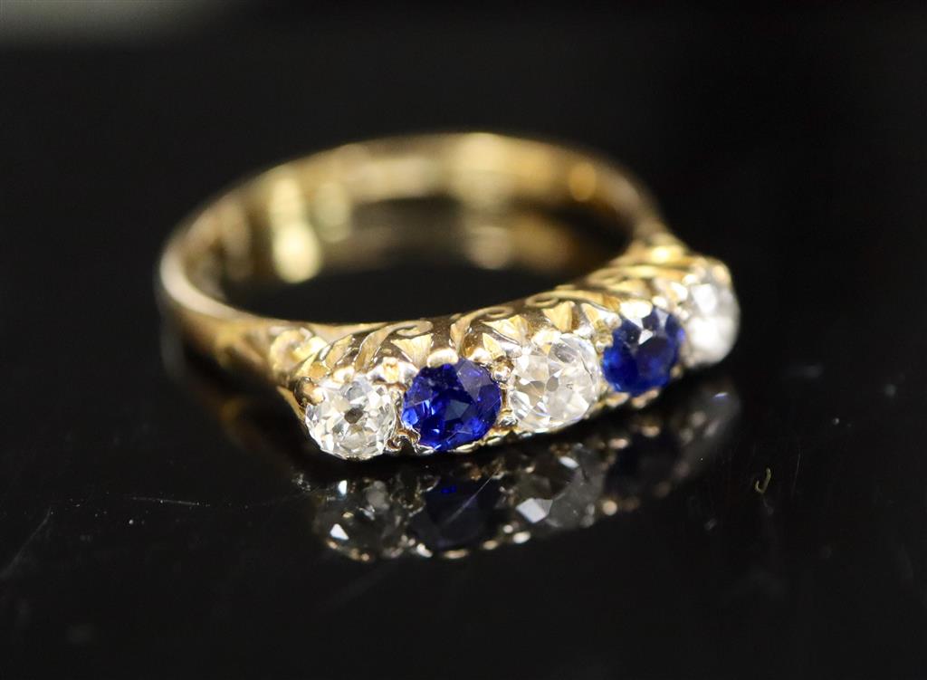 An early/mid 20th century 18ct gold and platinum, two stone sapphire and three stone diamond half hoop ring,